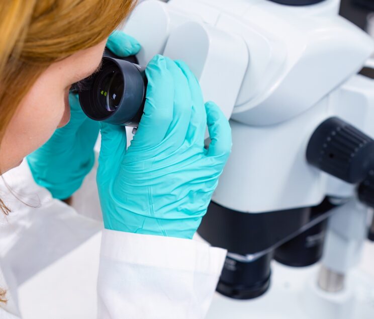 A scientist is utilizing a microscope, embodying the concepts of medical healthcare technology.