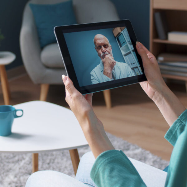 Woman having a video call with her doctor Woman having a video call with her doctor using a digital tablet, telemedicine concept